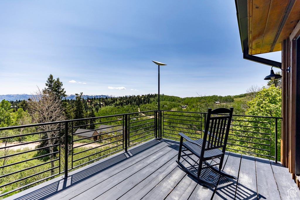 Wooden deck featuring a view of trees