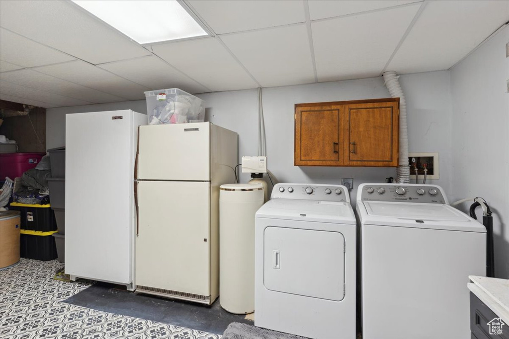 Washroom featuring cabinet space and separate washer and dryer