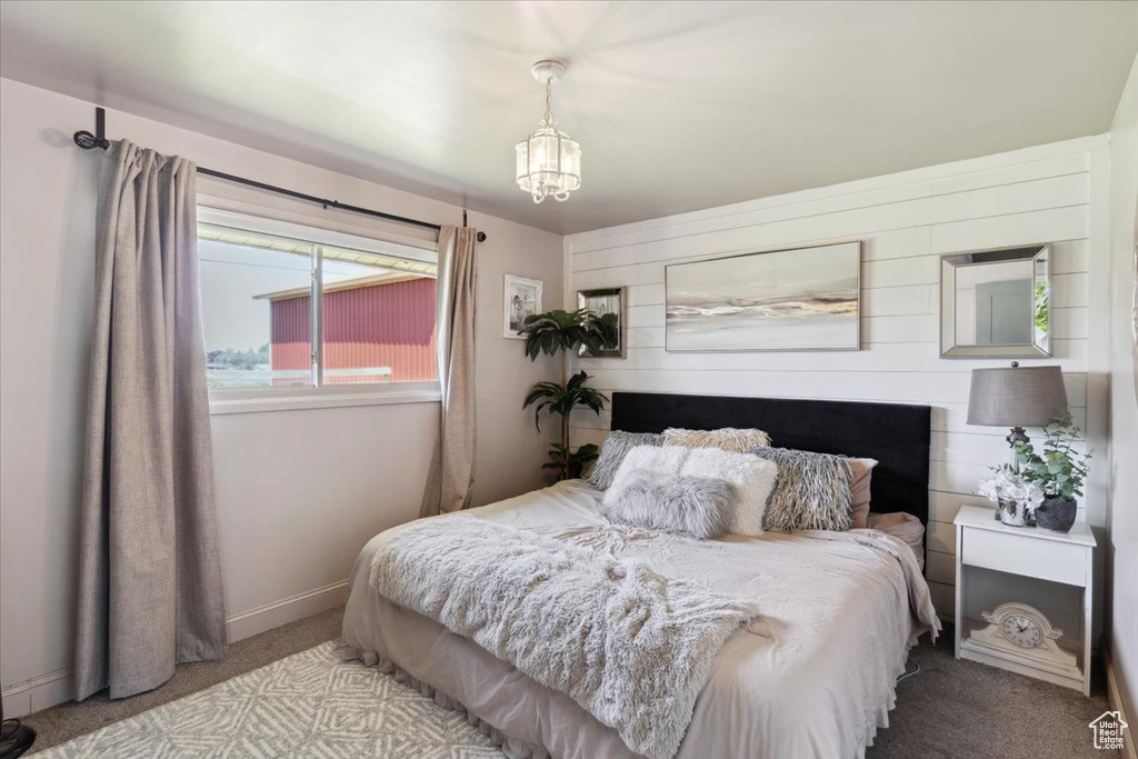 Bedroom featuring carpet flooring and a chandelier