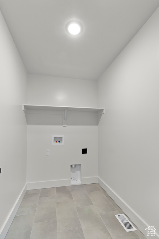 Washroom featuring baseboards and washer hookup