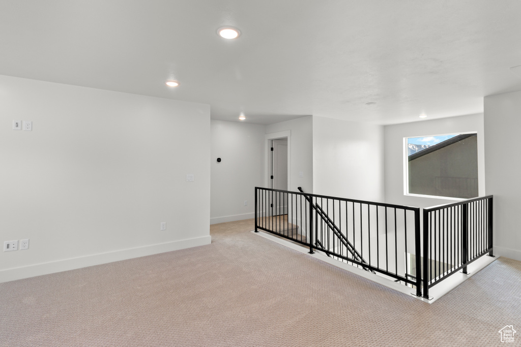 Carpeted empty room featuring recessed lighting and baseboards