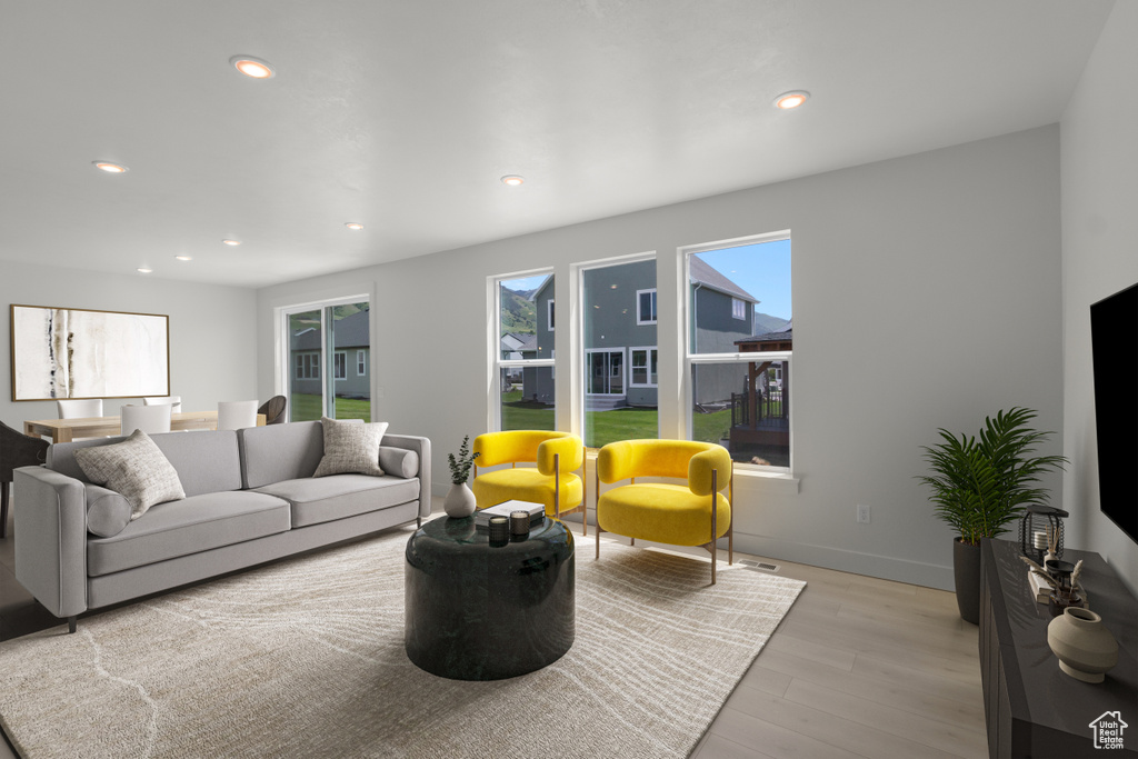 Living room featuring light wood-style flooring and recessed lighting
