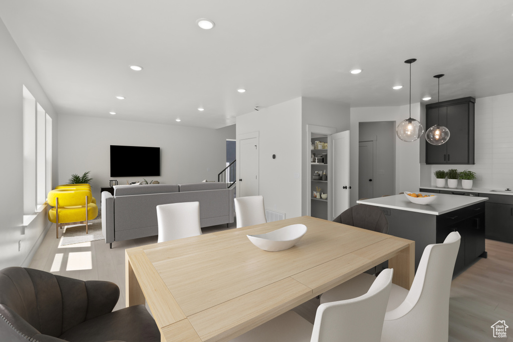 Dining room featuring light wood-style floors and recessed lighting