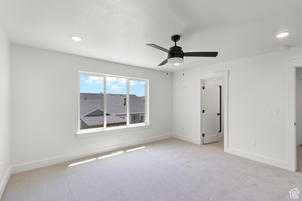 Unfurnished bedroom featuring light carpet, recessed lighting, and ceiling fan