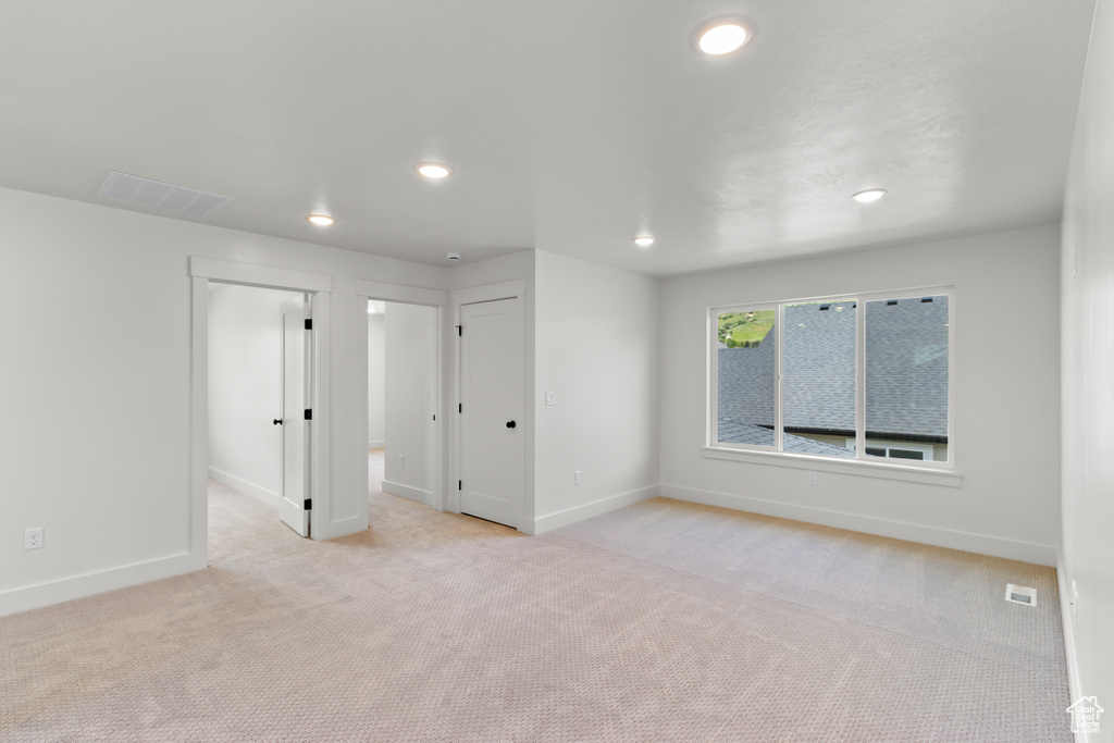 Unfurnished room featuring light colored carpet and recessed lighting