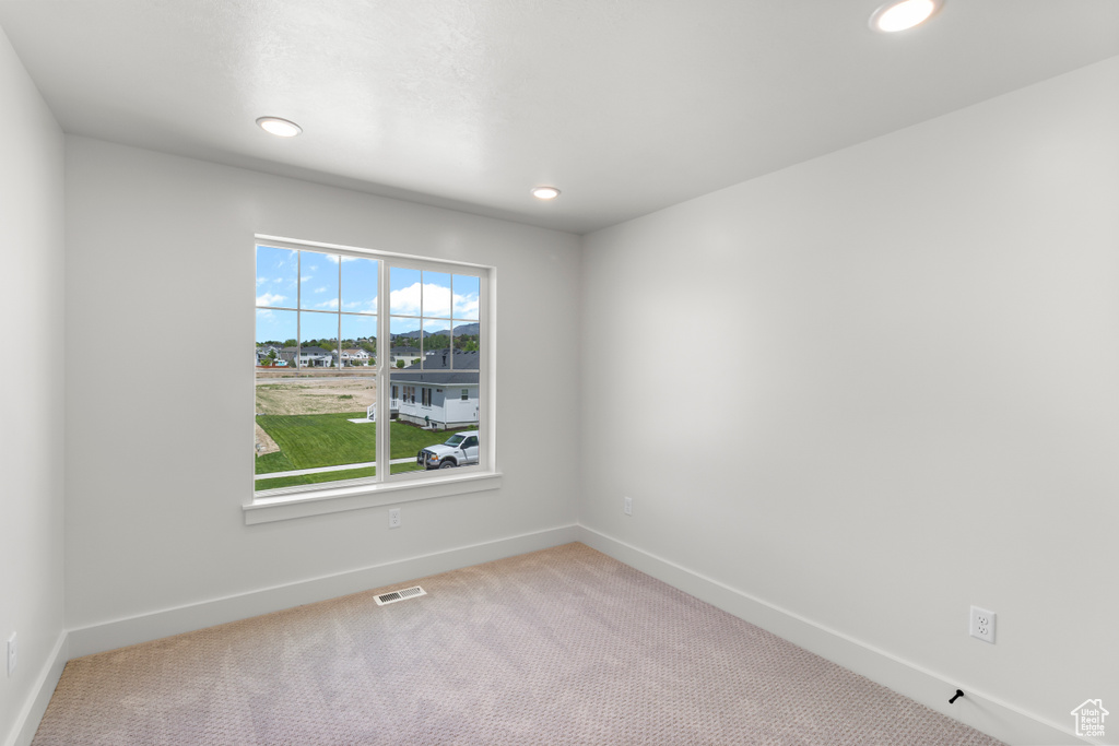 Carpeted spare room with recessed lighting