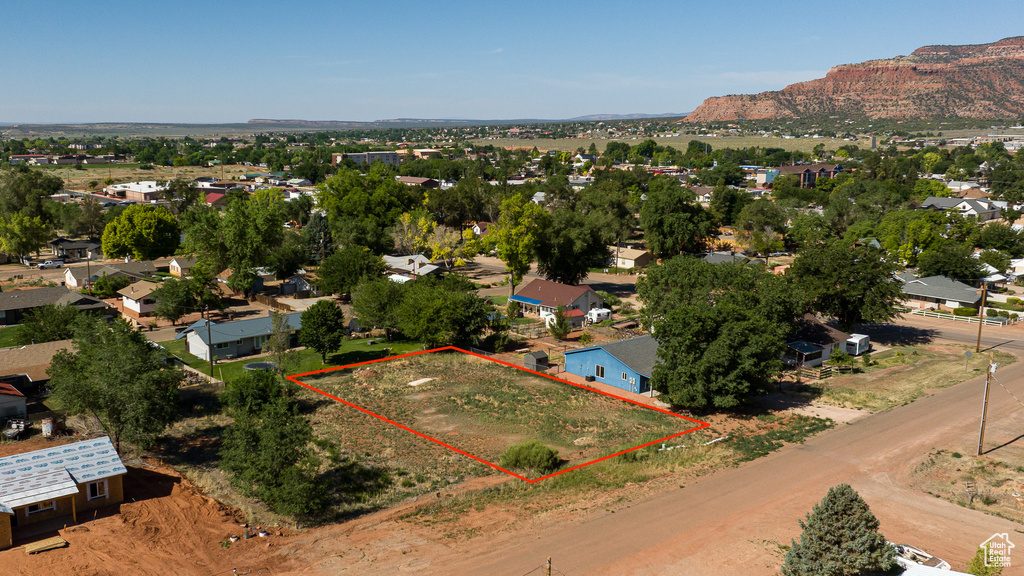 Aerial view of residential area featuring property parcel outlined and mountains
