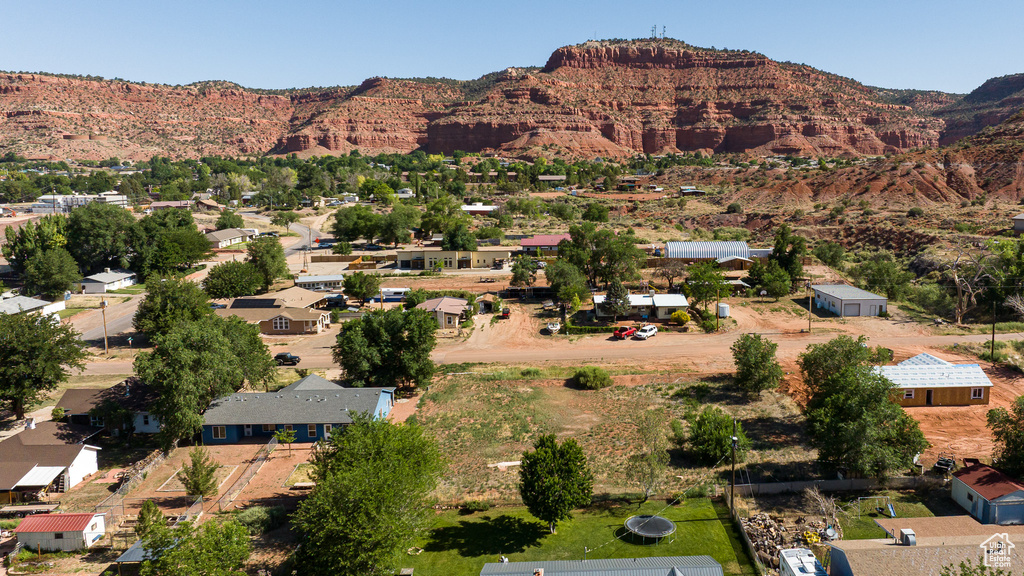 Aerial view of property and surrounding area with a mountainous background