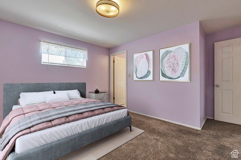 Bedroom featuring carpet flooring and baseboards