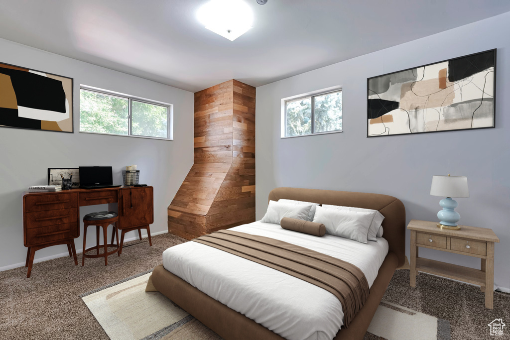Carpeted bedroom with multiple windows and an office area