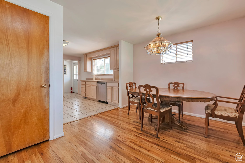 Dining space featuring a chandelier and light wood finished floors