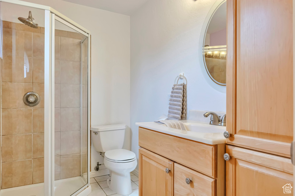 Full bath featuring tile patterned flooring, vanity, and a shower stall