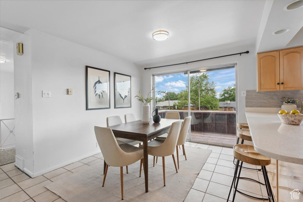 Dining area featuring light tile patterned flooring and baseboards