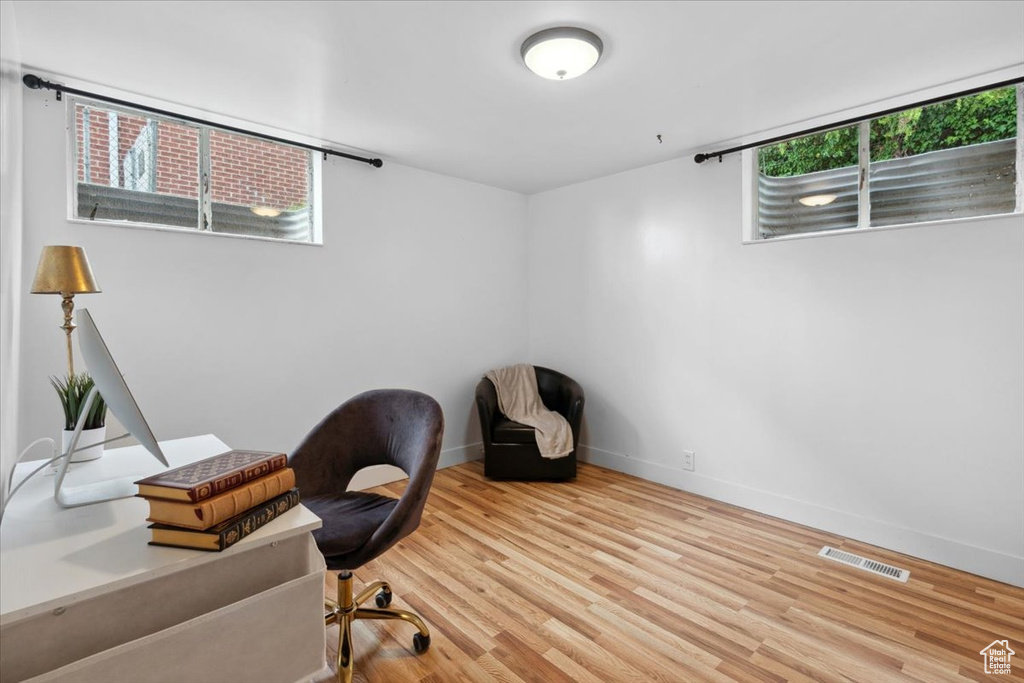 Home office with wood finished floors and baseboards