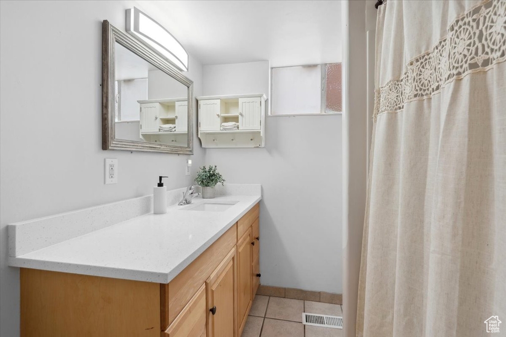 Full bathroom featuring vanity and tile patterned floors