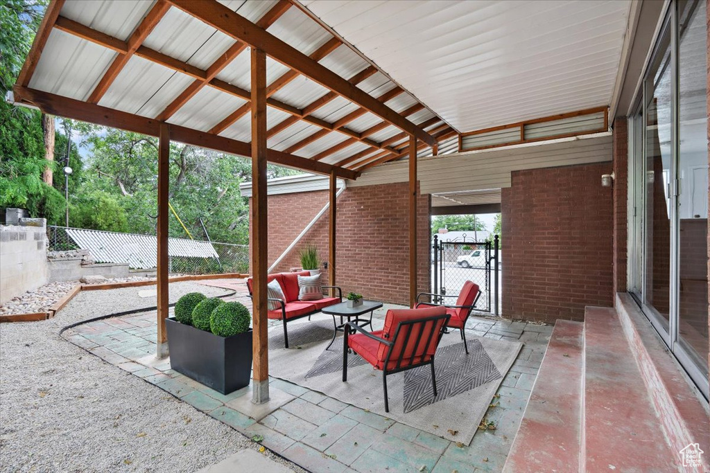 Fenced backyard featuring a patio area, an outdoor living space, and a gate