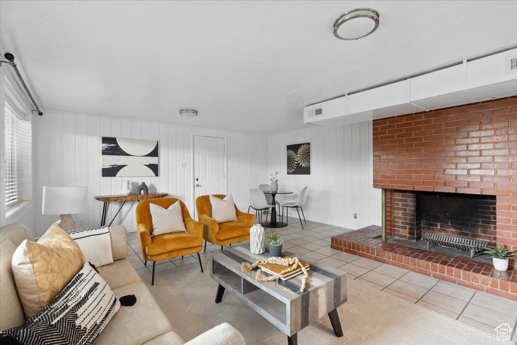 Living room with tile patterned flooring and a fireplace