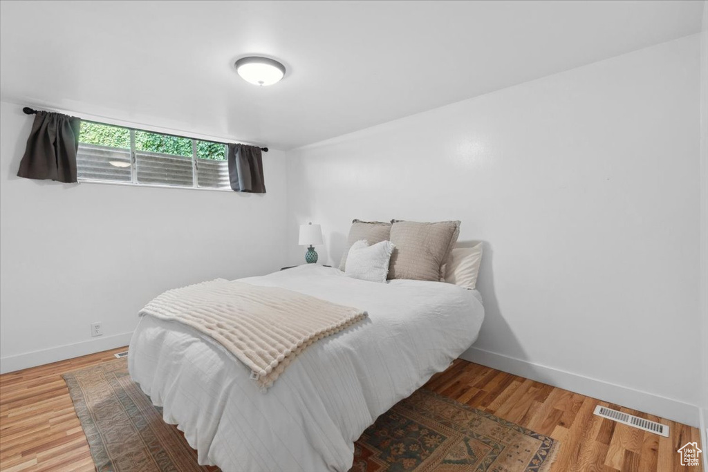 Bedroom with baseboards and wood finished floors
