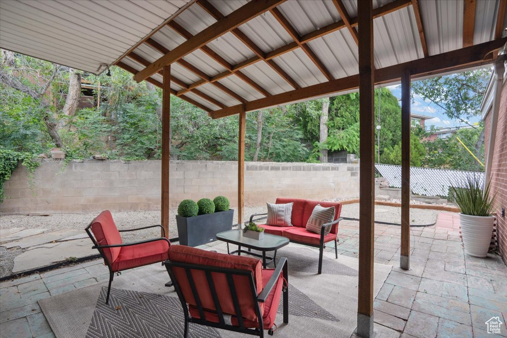 Fenced backyard featuring a patio and an outdoor hangout area