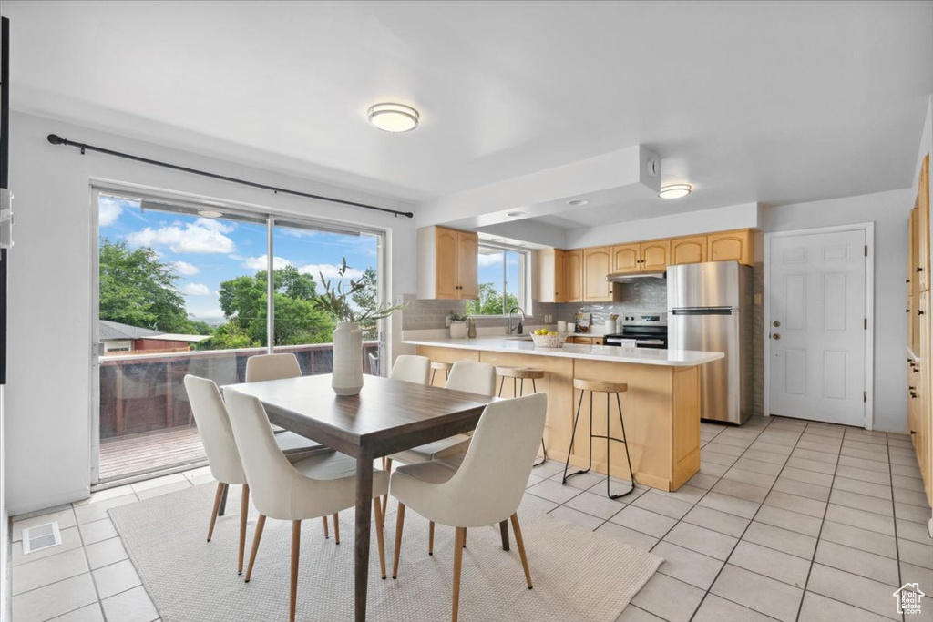 Dining space featuring light tile patterned flooring
