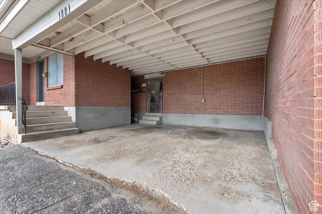 View of patio with entry steps and an attached carport