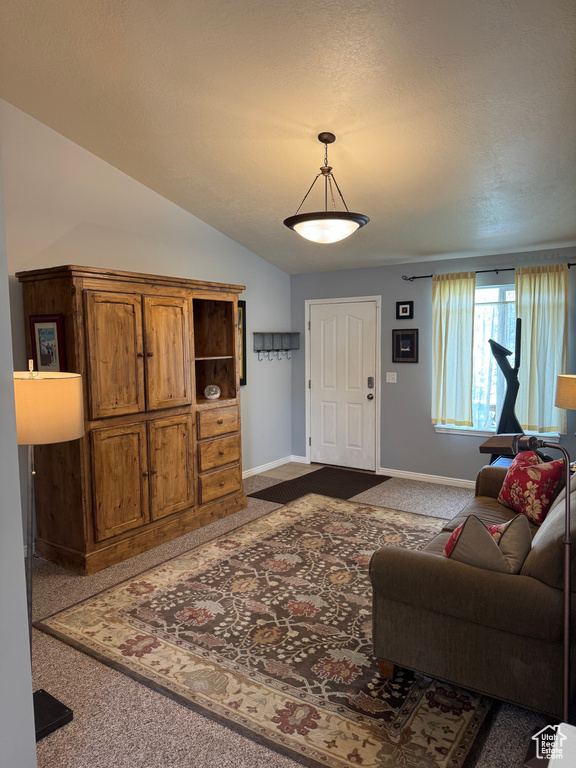 Living room featuring dark carpet and lofted ceiling