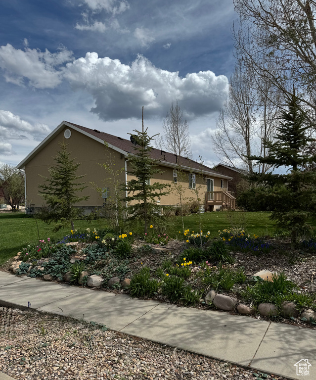 View of property exterior featuring a yard and stucco siding