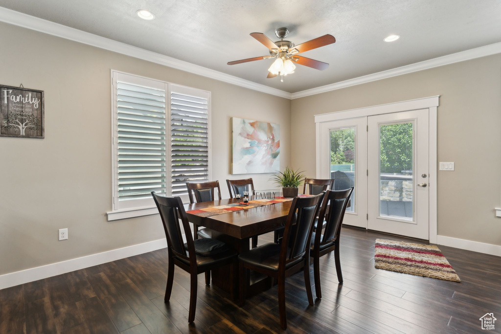 Dining room featuring a ceiling fan, ornamental molding, dark wood-style flooring, baseboards, and recessed lighting