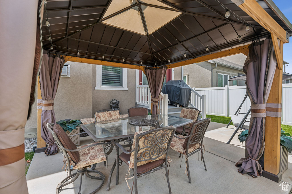 View of patio / terrace with a gazebo, outdoor dining space, and grilling area