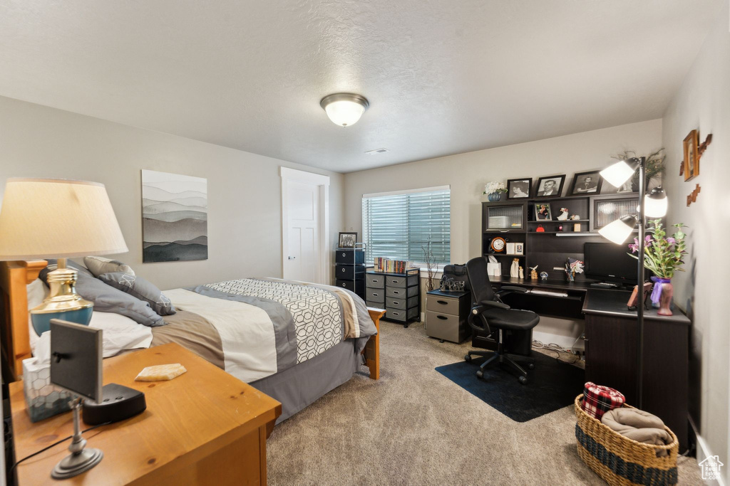 Bedroom with carpet and a desk