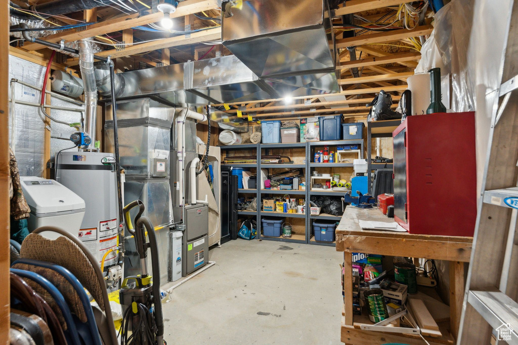 Unfinished basement featuring water heater and heating unit