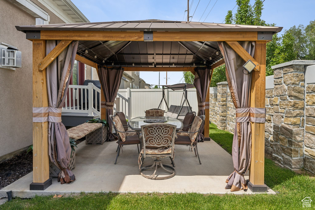 View of patio / terrace featuring a gazebo and outdoor dining space