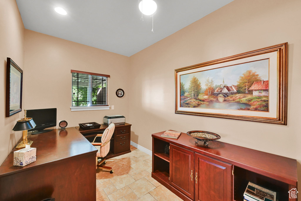 Office with light stone finish floors and baseboards