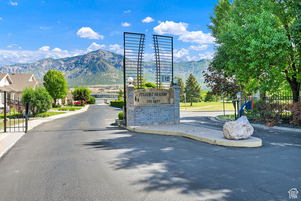 View of asphalt street featuring a mountain view and curbs