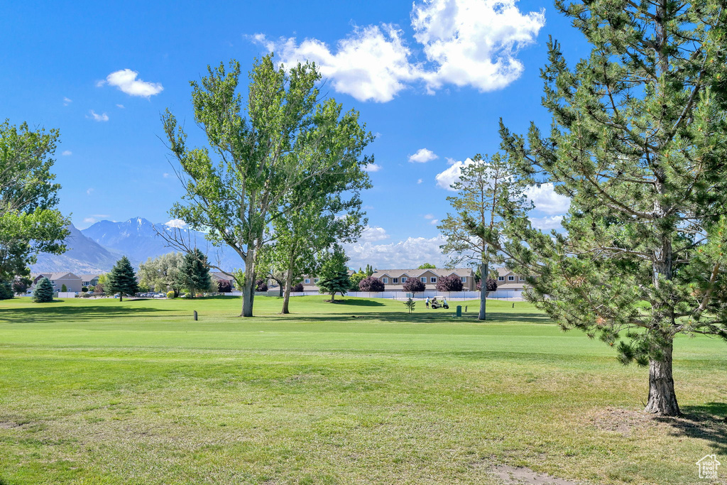 View of property\\\'s community with a mountain view, a yard, a residential view, and view of golf course