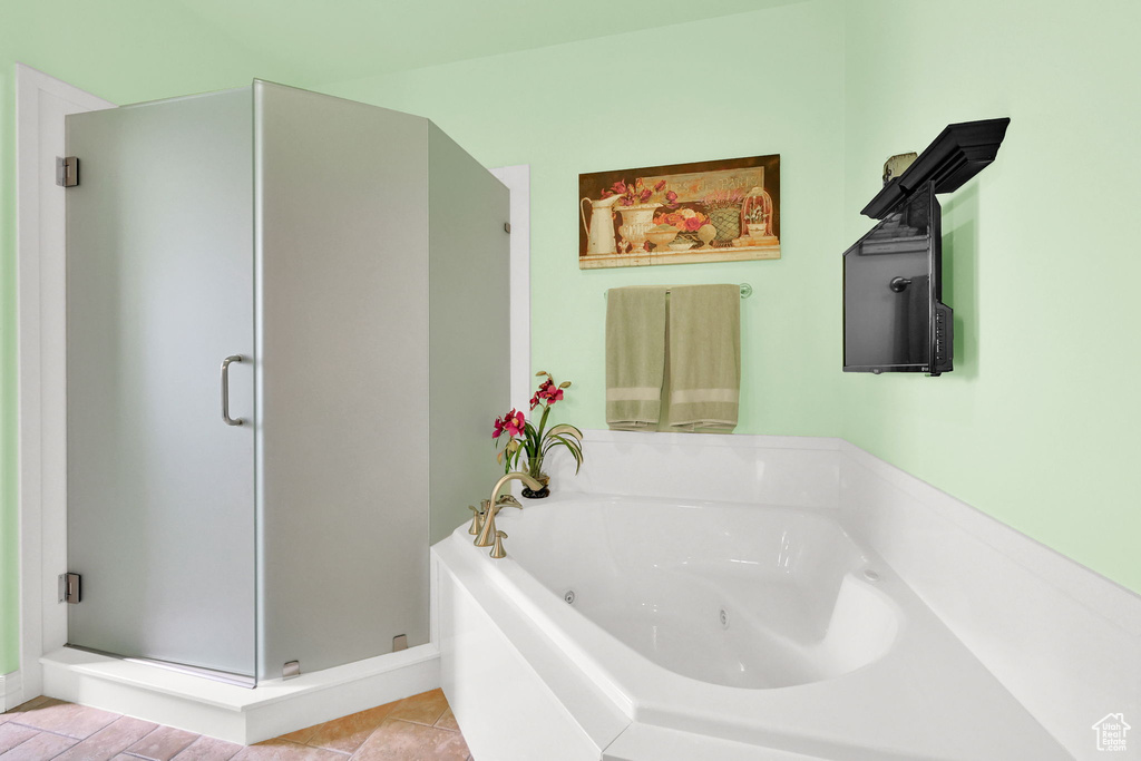 Bathroom featuring a shower stall and a jetted tub