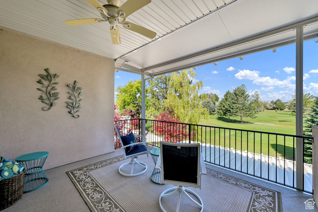 Patio / terrace with ceiling fan and golf course view