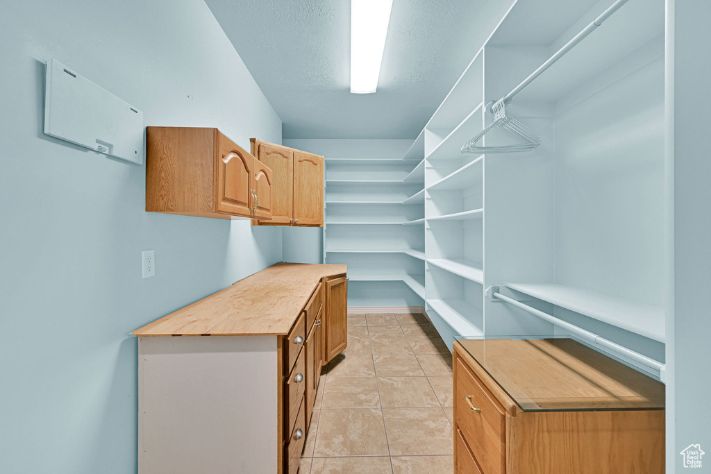 Spacious closet with light tile patterned flooring
