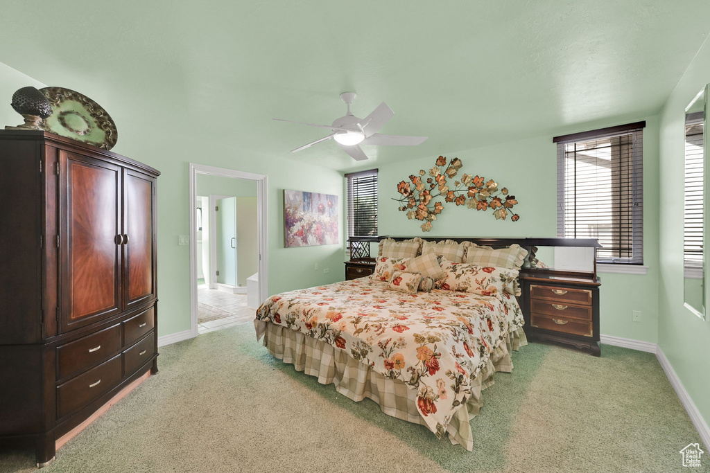 Bedroom featuring light carpet and a ceiling fan