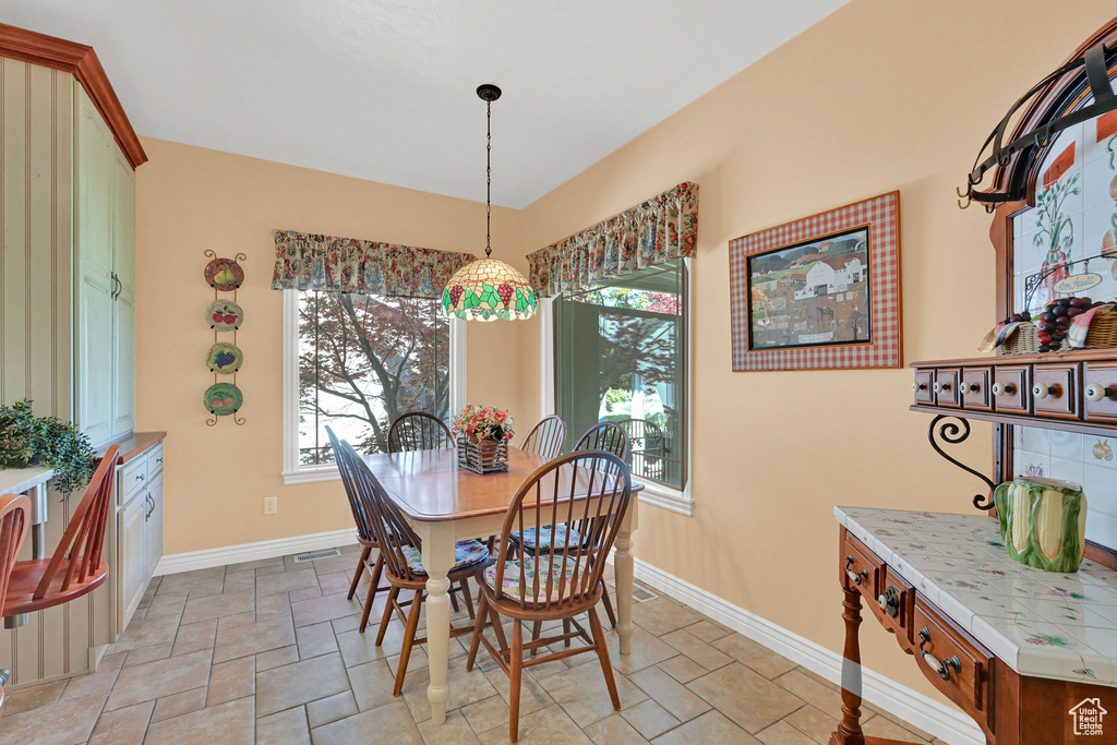 Dining space featuring plenty of natural light and stone tile flooring