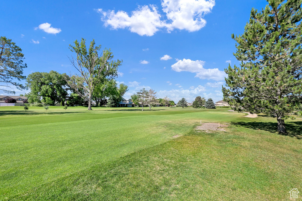 View of property\\\'s community featuring a yard and golf course view