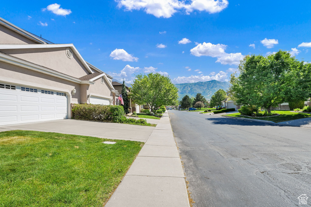 View of asphalt road featuring a mountain view and a residential view