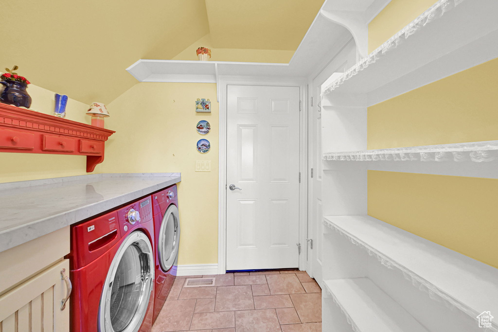Laundry area with separate washer and dryer and baseboards
