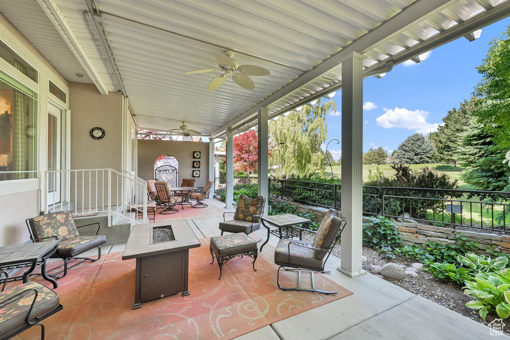 View of patio / terrace featuring a fire pit and a ceiling fan