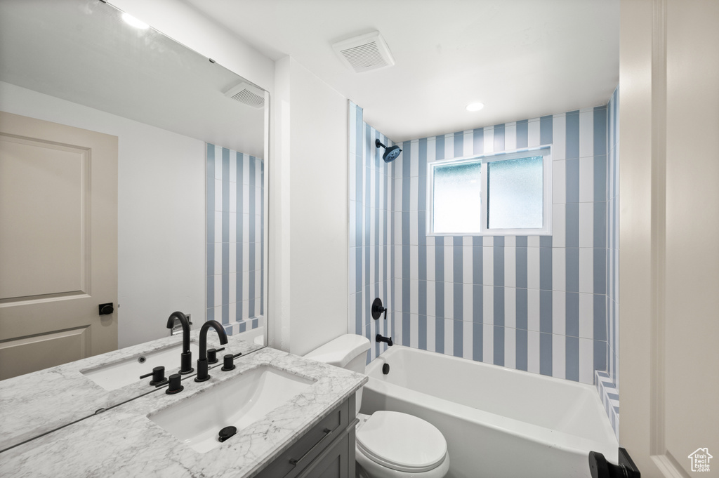 Bathroom featuring vanity and washtub / shower combination