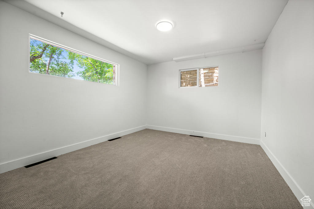 Spare room with baseboards and carpet