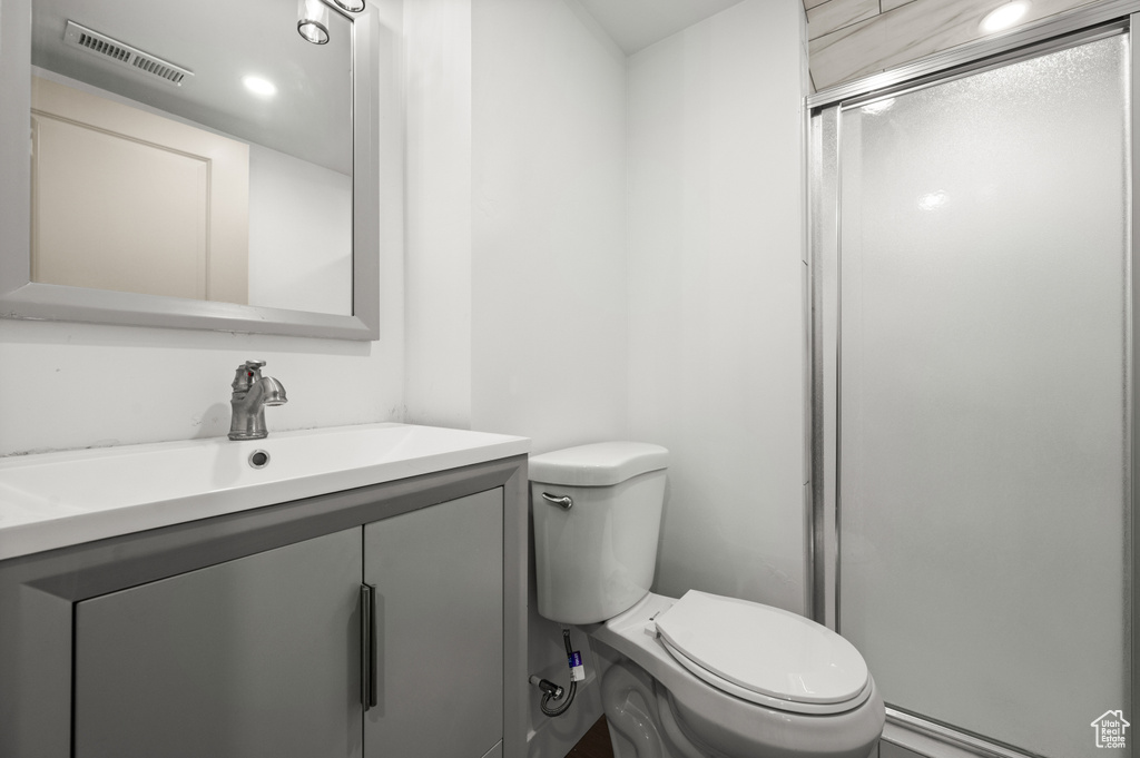 Bathroom with a stall shower and vanity