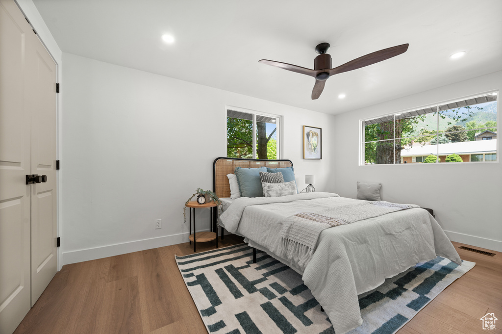 Bedroom with multiple windows, recessed lighting, wood finished floors, and ceiling fan