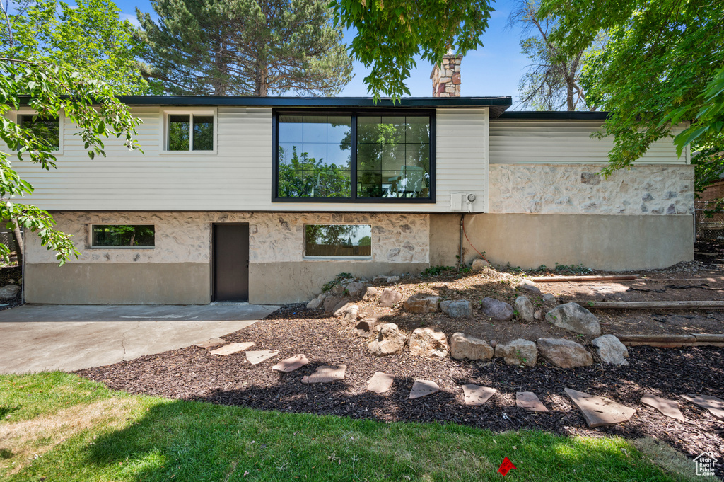 View of front of house featuring a patio area and a chimney