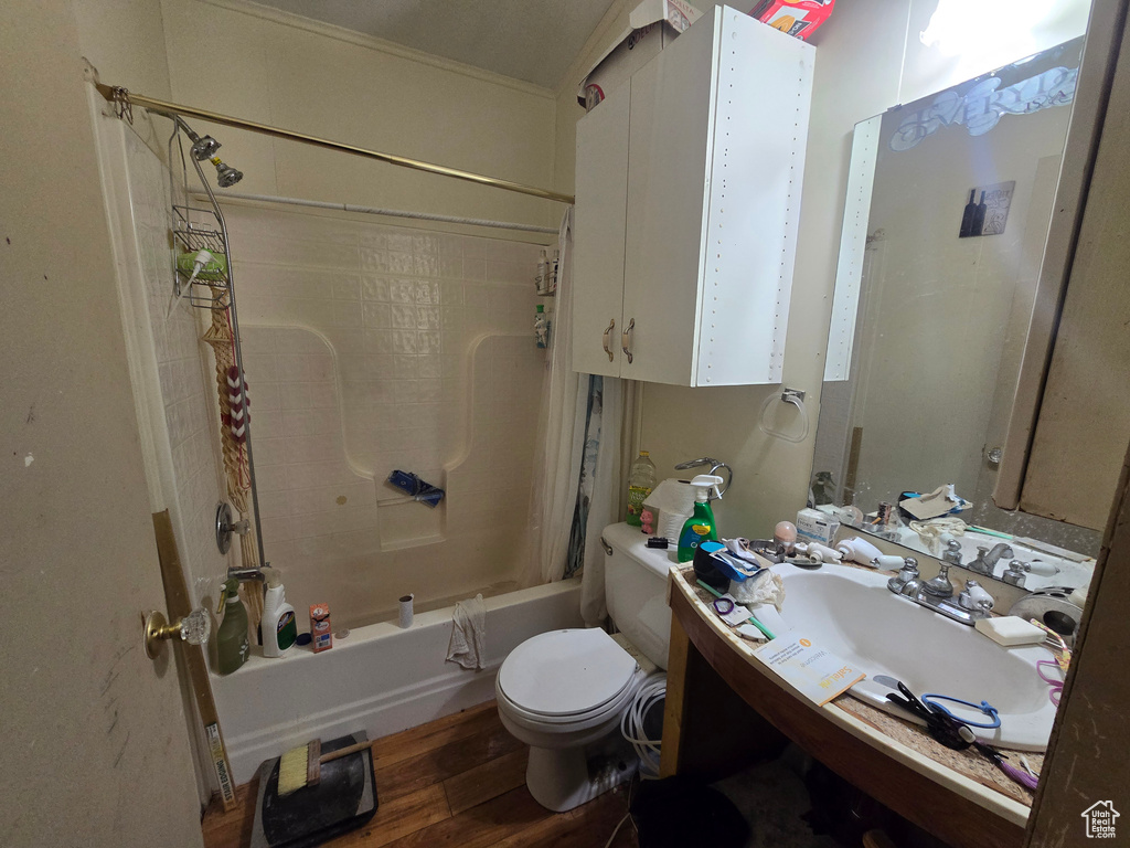Full bathroom with shower / bathtub combination with curtain and wood finished floors